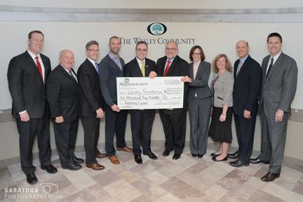 Officials from The Adirondack Trust Company presenting a donation to The Wesley Community