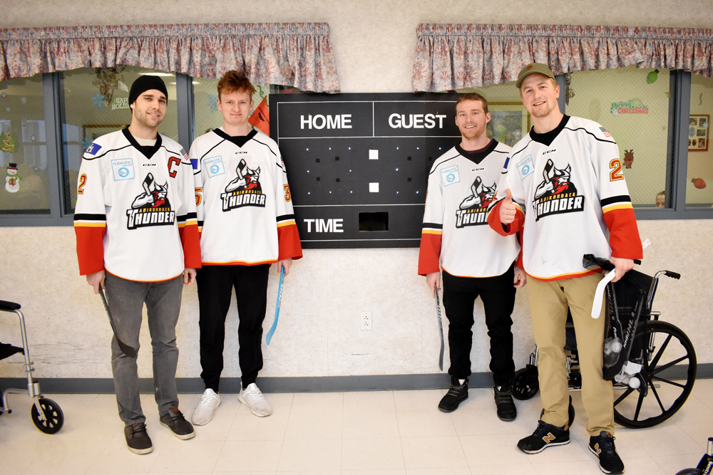 Hockey Players in front of score board