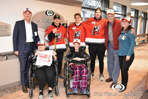 Players from the Adirondack Thunder hockey team visit seniors at The Wesley Community in Saratoga Springs, NY on Tuesday, January 15. Adirondack Thunder players (pictured in the middle from left to right) Dylan Walchuk, Will Smith and Dillon Kelley spent the afternoon engaging with seniors and staff at the Wesley Health Care Center.