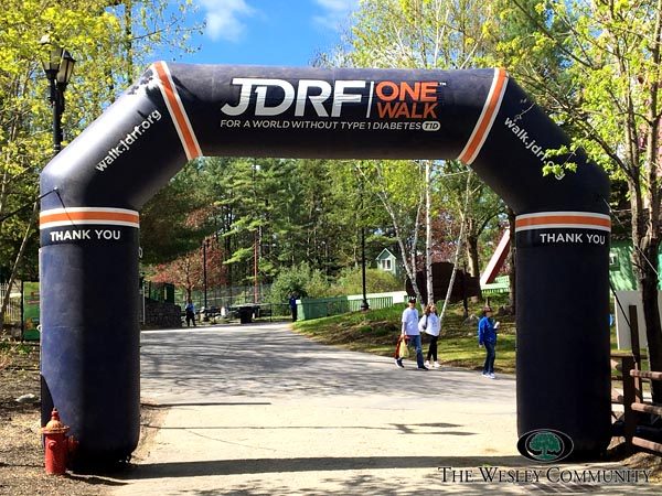 JDRF One Walk finish line. Trres, sky and an inflatable arch to mark the finish.
