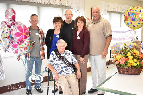 A multigenerational family celebrating a woman's 100th birthday.