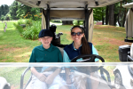 woman and boy in golf cart