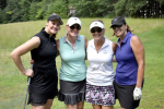 group of smiling women with golf clubs