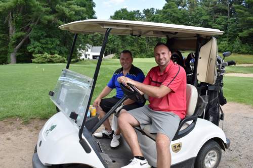 pair of men on golf cart