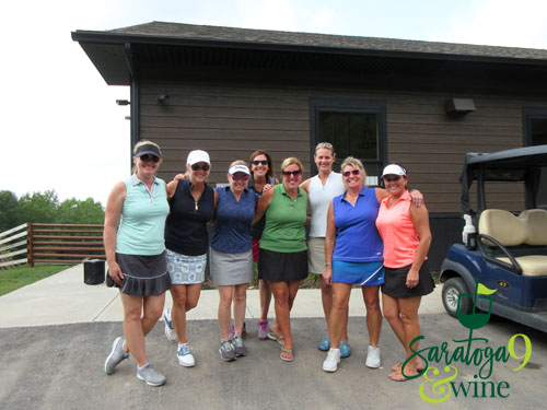 group of smiling women with golf cart