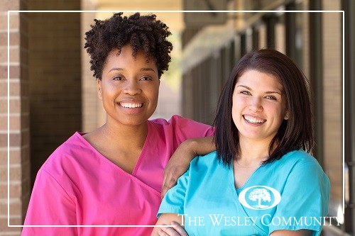 Two nurses posing for a picture.