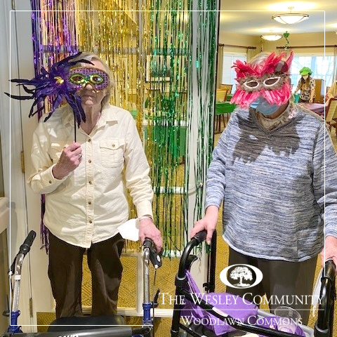 Two senior girlfriends in Mardis Gras Masks