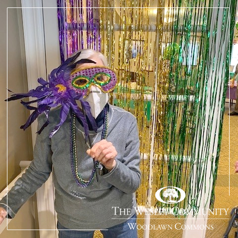 A woman in a Mardis Gras mask.